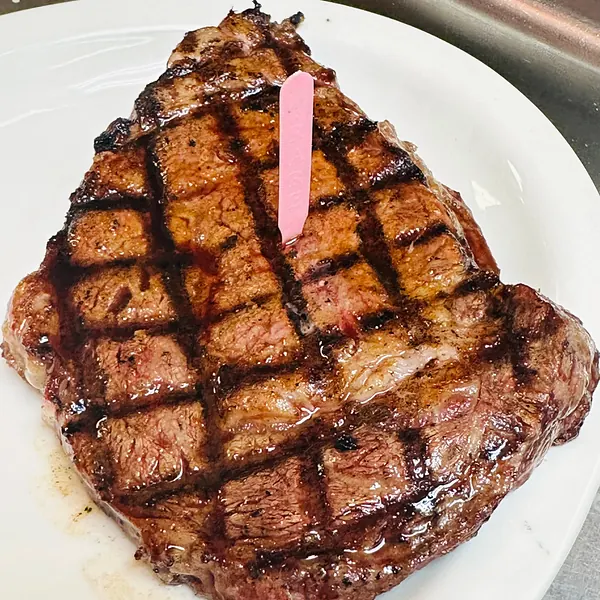 A grilled 14 ounce ribeye steak with crosshatch grill marks