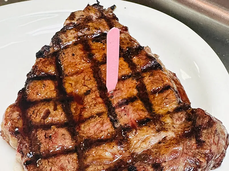 A grilled 14 ounce ribeye steak with crosshatch grill marks