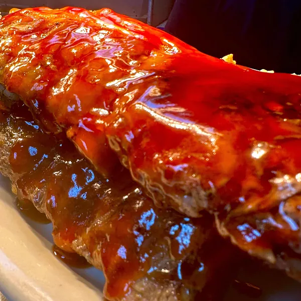 A rack of Marcy's baby back ribs glazed in house-made BBQ sauce