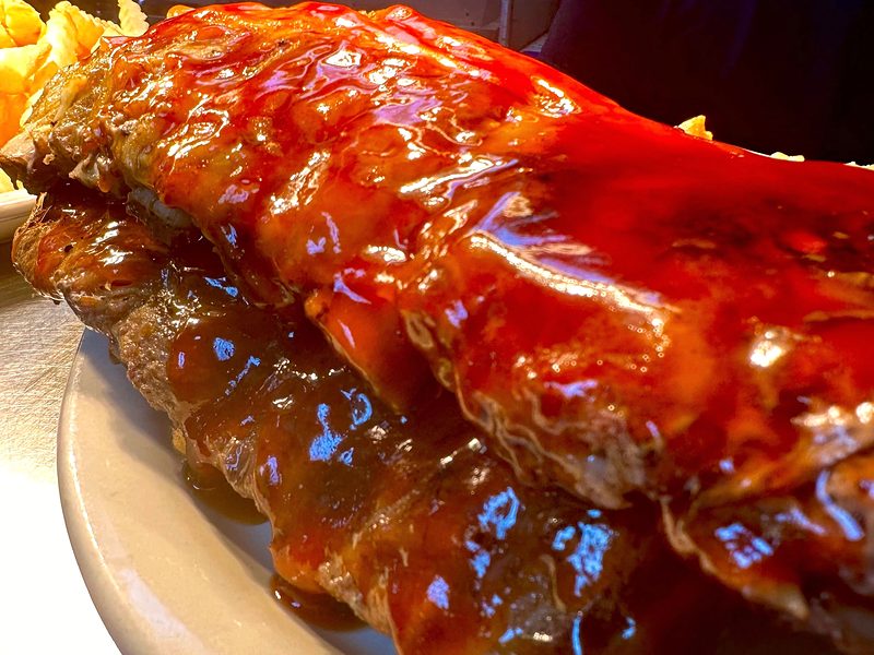 A rack of Marcy's baby back ribs glazed in house-made BBQ sauce